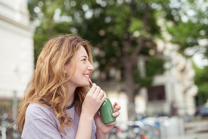 Woman Drinking Juice Outside