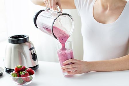 Woman Using A Glass Blender