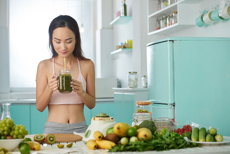 Woman Drinking Green Smoothie Fresh From Blender