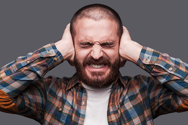 Man Covering Ears Because Of Loud Juicer