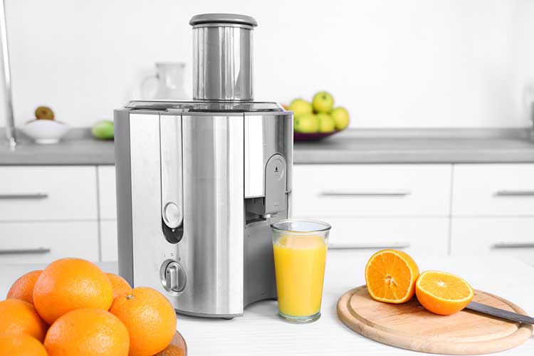 Orange Juice Being made In A Juicer