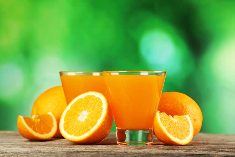 Oranges, Orange Juice and a Green Background