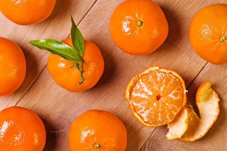 Oranges getting peeled ready for juicing